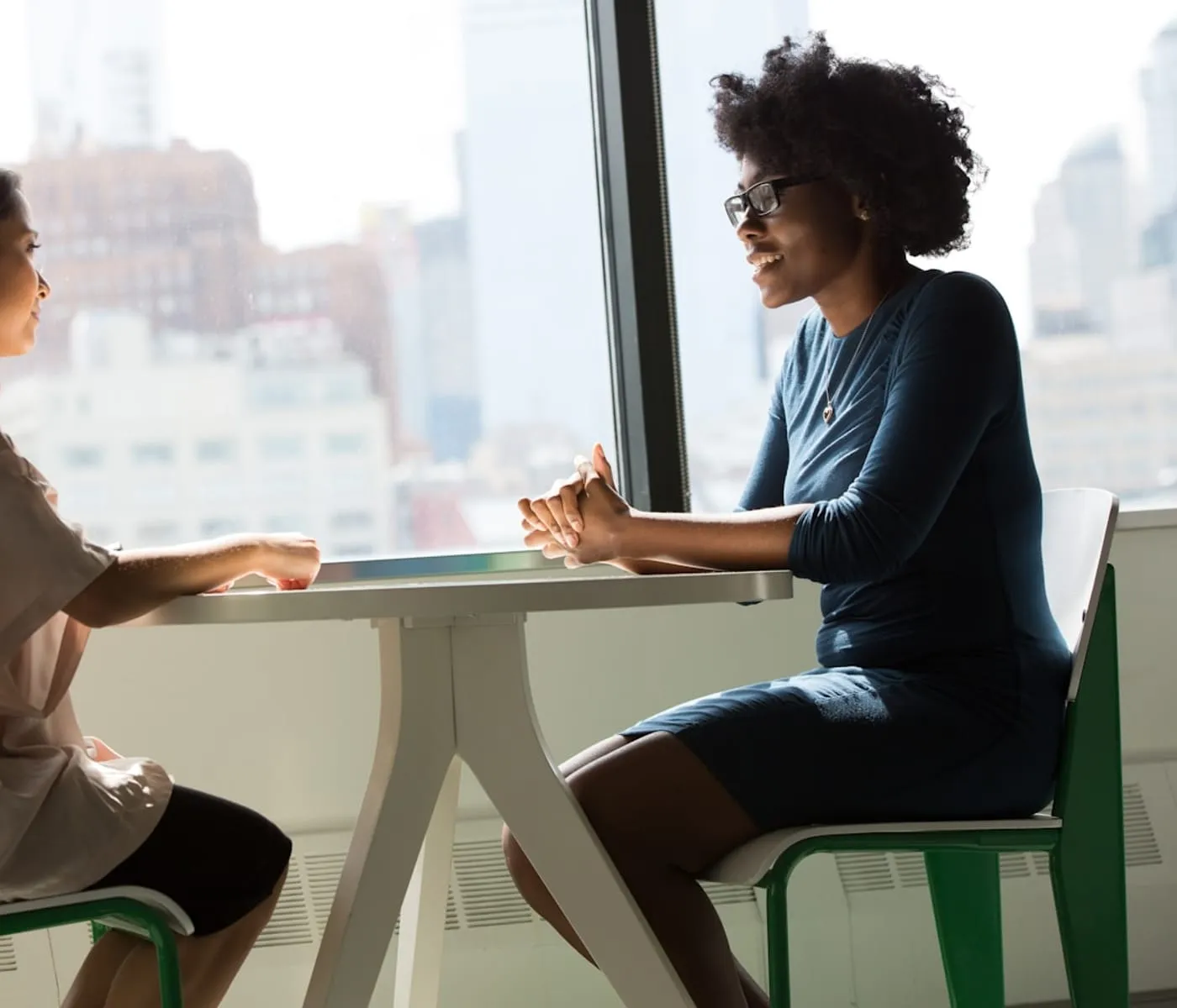 A web designer and a business owner reviewing a website together at a table